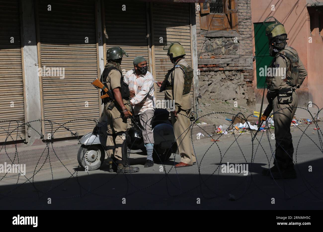 (170529) -- SRINAGAR, May 29, 2017 -- An Indian paramilitary trooper checks the identity card of a man during curfew-like restrictions in downtown Srinagar, summer capital of Indian-controlled Kashmir, May 29, 2017. Curfew-like restrictions have been imposed in several areas of Srinagar to prevent protests and clashes. ) (zcc) KASHMIR-SRINAGAR-RESTRICTIONS JavedxDar PUBLICATIONxNOTxINxCHN   Srinagar May 29 2017 to Indian paramilitary Trooper Checks The Identity Card of a Man during Curfew Like Restrictions in Downtown Srinagar Summer Capital of Indian Controlled Kashmir May 29 2017 Curfew Like Stock Photo