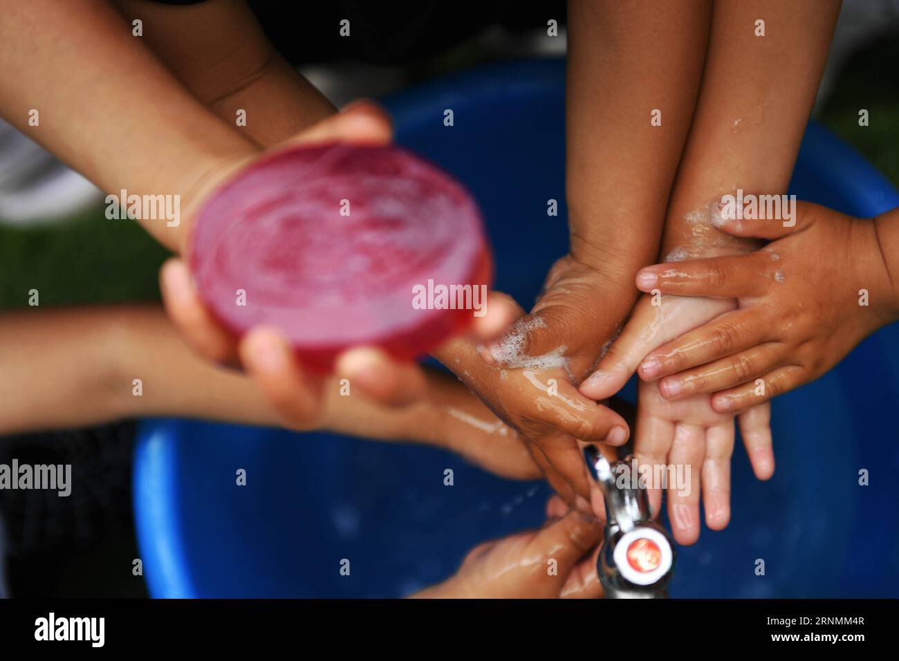 (170603) -- HUACHI, June 3, 2017 -- Children wash their hands before meals at a kindergarten in Xinbao Village of Huachi County, northwest China s Gansu Province, June 3, 2017. To improve the hygiene education in remote areas, China Develpment Research Foundation and Unilever carried out a project to promote hand wash among children in classes. The project so far has covered more than 10,000 rural children in serveral provinces of China. ) (ry) CHINA-GANSU-HUACHI-RURAL KINDERGARTEN-EDUCATION (CN) ChenxBin PUBLICATIONxNOTxINxCHN   Huachi June 3 2017 Children Wash their Hands Before Meals AT a K Stock Photo