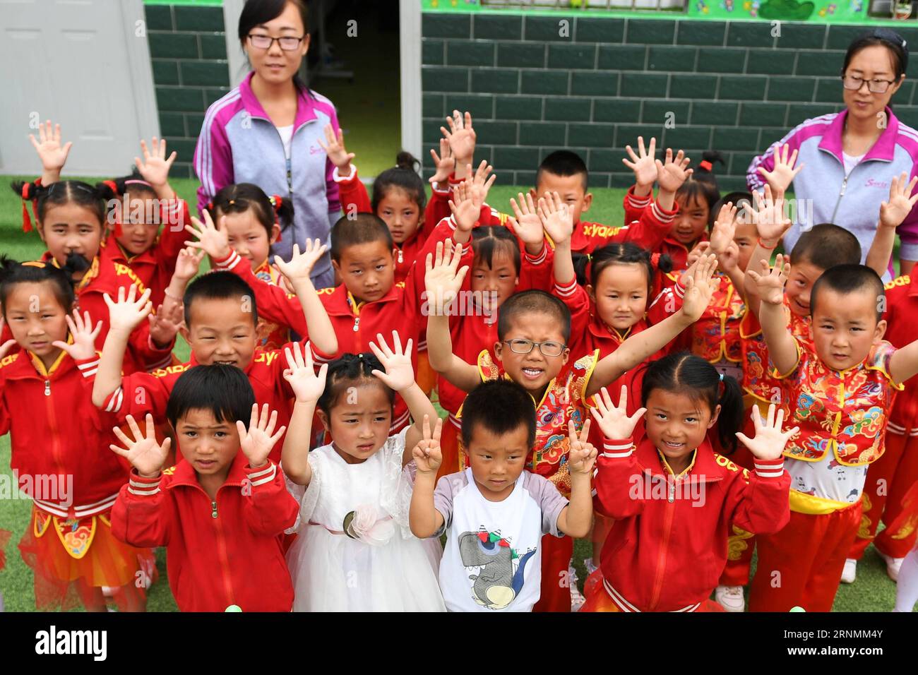 (170603) -- HUACHI, June 3, 2017 -- Children show their clean hands after washing hands at a kindergarten in Xinbao Village of Huachi County, northwest China s Gansu Province, June 3, 2017. To improve the hygiene education in remote areas, China Develpment Research Foundation and Unilever carried out a project to promote hand wash among children in classes. The project so far has covered more than 10,000 rural children in serveral provinces of China. ) (ry) CHINA-GANSU-HUACHI-RURAL KINDERGARTEN-EDUCATION (CN) ChenxBin PUBLICATIONxNOTxINxCHN   Huachi June 3 2017 Children Show their Clean Hands Stock Photo