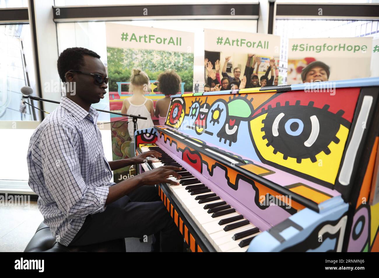 (170605) -- NEW YORK, June 5, 2017 -- Keer Deng, a visually disabled hobbyist, plays the piano during the opening event of Sing for Hope Pianos in New York, the United States, on June 5, 2017. Sing for Hope Pianos, an annual public arts project in New York, kicked off here on Monday. From June 5 to June 25, as a celebration of the work Sing for Hope does in communities year-round, 60 Sing for Hope Pianos will be placed in parks and public spaces in high traffic locations across all five boroughs in New York for everyone to play. After the public installation concludes on June 25, 50 of the 201 Stock Photo