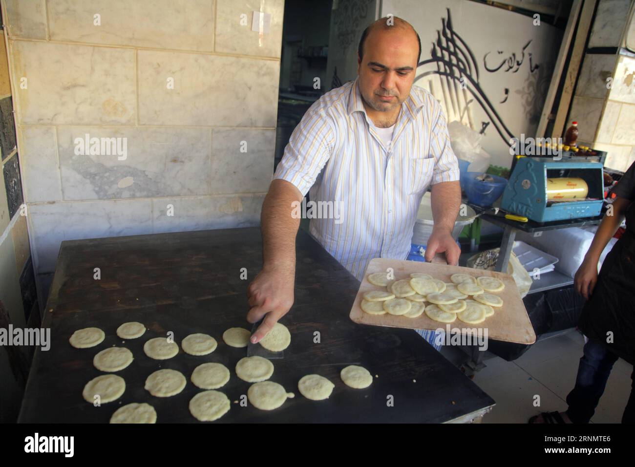 (170610) -- CAIRO, June 10, 2017 -- A Syrian makes pastries at Giza s 6th of October city in Greater Cairo, Egypt, on June 3, 2017. Thousands of Syrians fled the six-year conflict back home and found refuge in Egypt, forming a large community at Giza s 6th of October city in Greater Cairo. Although there are no fixed statistics about the number of Syrian refugees in Egypt, the Egyptian foreign ministry once said it was half a million. Egypt does not build refugee camps for them but it simply allows them to freely work and engage in the Egyptian society. ) EGYPT-CAIRO-SYRIANS-DAILY LIFE AhmedxG Stock Photo