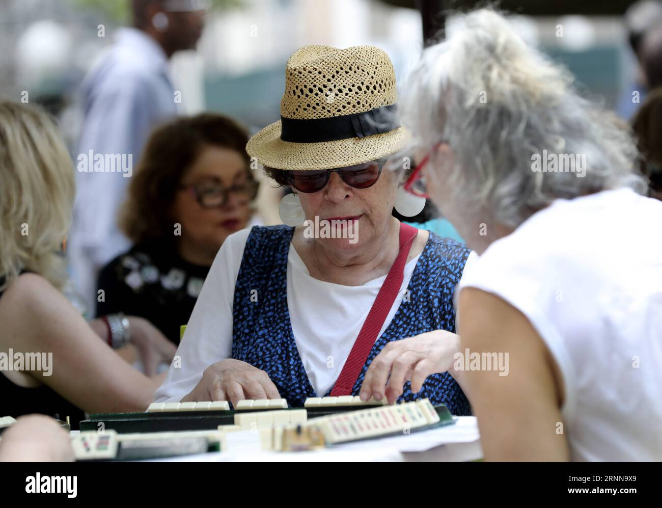 (170703) -- NEW YORK, July 3, 2017 -- Hobbyists play Mah Jongg during the Mah Jongg Marathon event at Bryant Park in New York City, the United States, on July 3, 2017. According to event organizer Linda Fisher, the event is organized to provide a place for Mah Jongg hobbyists to communicate with each other and promote the game to more people. Mah Jongg, originated from China, was introduced to the United States in the 1920s. ) U.S.-NEW YORK-MAH JONGG MARATHON WangxYing PUBLICATIONxNOTxINxCHN   New York July 3 2017 hobbyists Play Mah Jongg during The Mah Jongg Marathon Event AT Bryant Park in N Stock Photo
