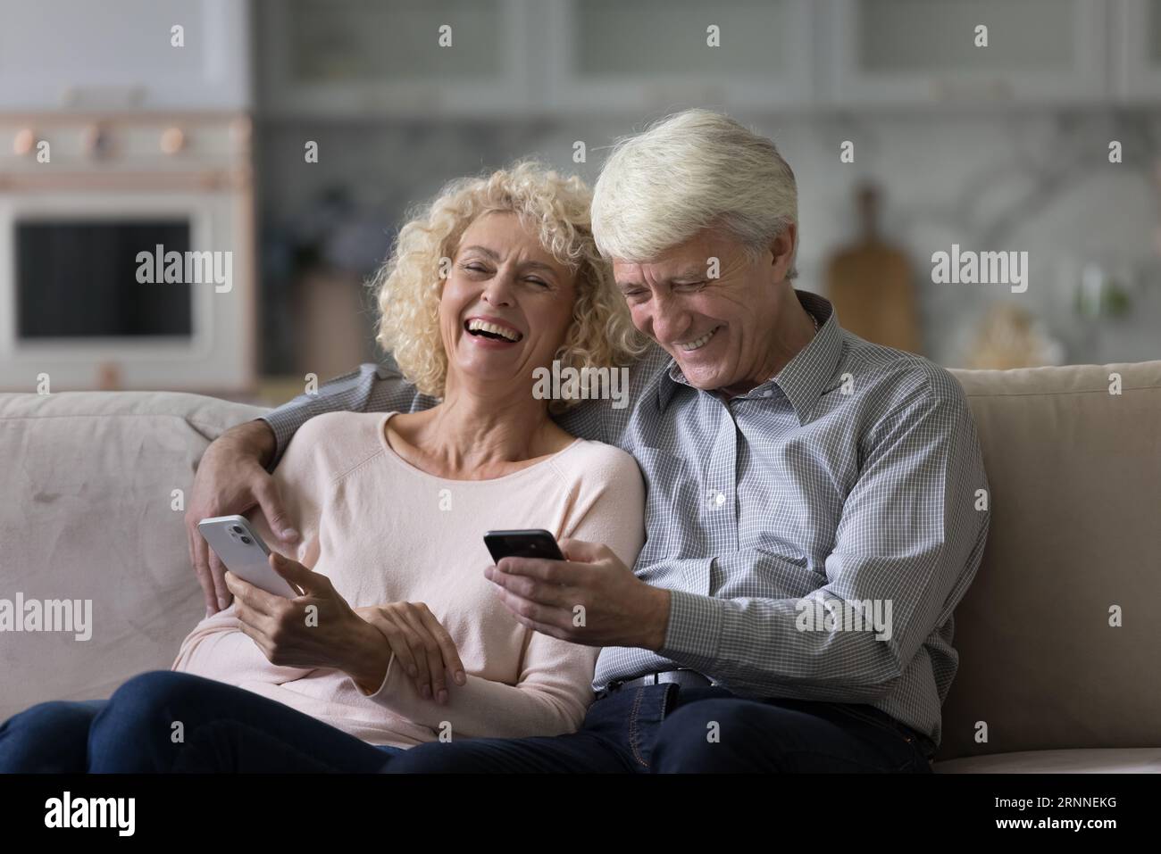 Cheerful senior married couple using applications, virtual services Stock Photo