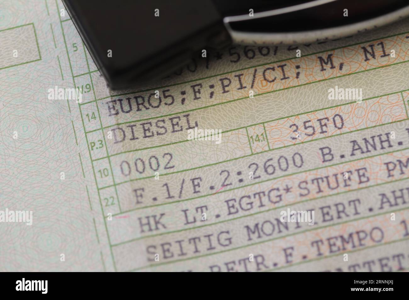 a vehicle registration document with the words (Diesel, Euro 5) and a red pen Stock Photo Alamy