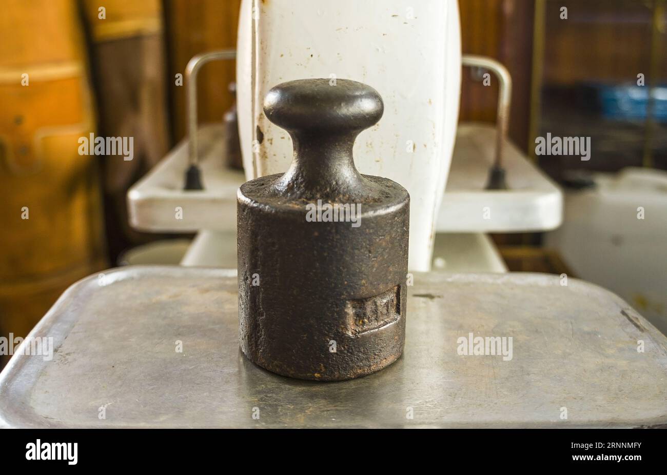 Kettlebell on scales Weight concept and product weighing. Vintage mechanical scales Stock Photo