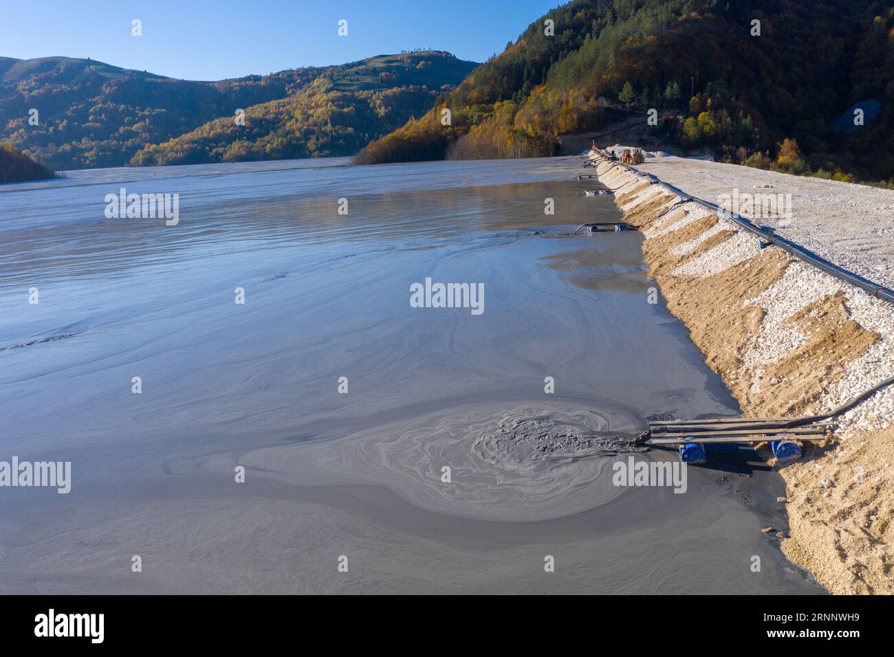 Aerial view of heavy metal contamination from a copper mine. Mining residual waters discharging into decanting pond. Geamana, Romania Stock Photo