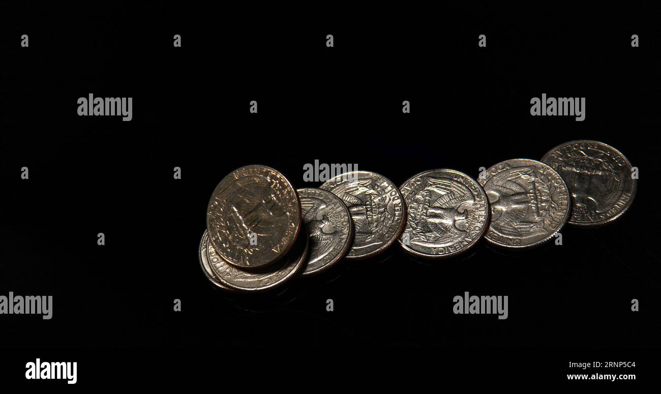 Quarter Dollar Coins Falling, Rolling and Sliding on Black Background ...