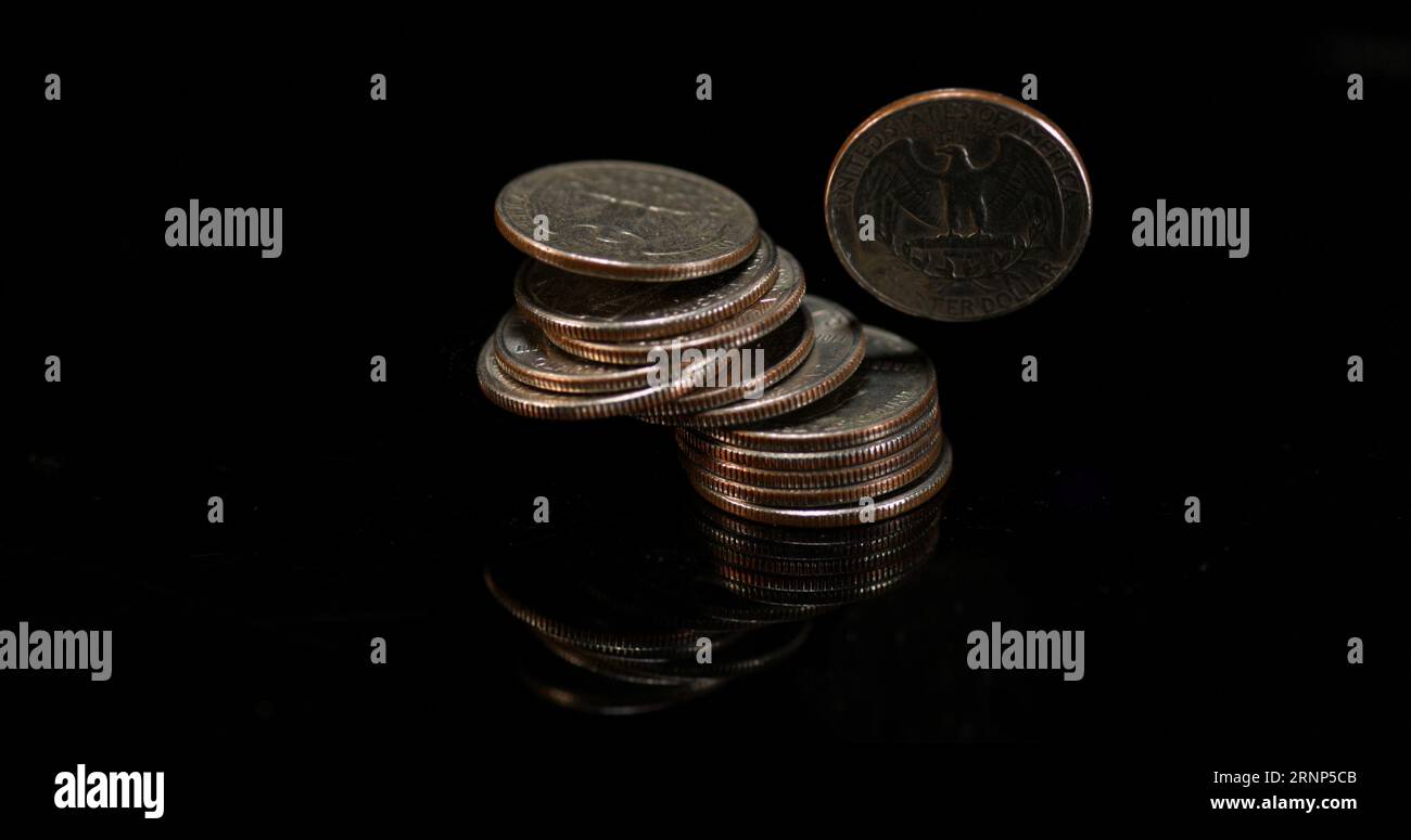 Quarter Dollar Coins Falling, Rolling and Sliding on Black Background ...
