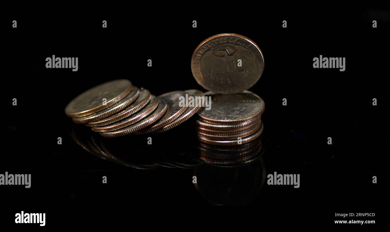 Quarter Dollar Coins Falling, Rolling and Sliding on Black Background ...