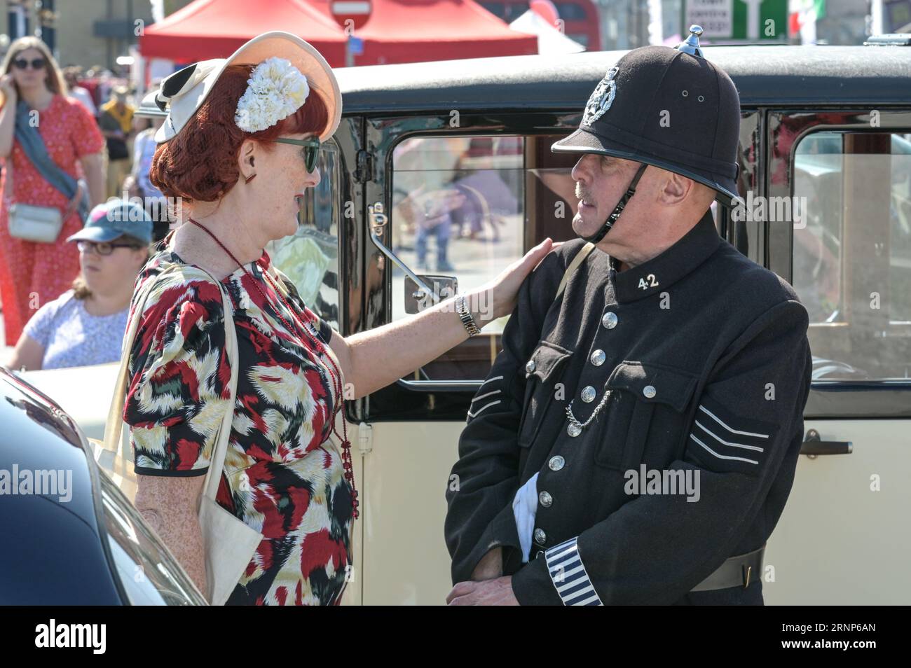 Morecambe, Lancashire - September 2nd 2023 - Visitors enjoyed Morecambe's Vintage By The Sea festival on Saturday. Many of whom came dressed in vintage clothing and soaked up the atmosphere. A man took a rest in the shade of his vintage car reading a newspaper as the blaring sun beated down. Credit: Stop Press Media/Alamy Live News Stock Photo