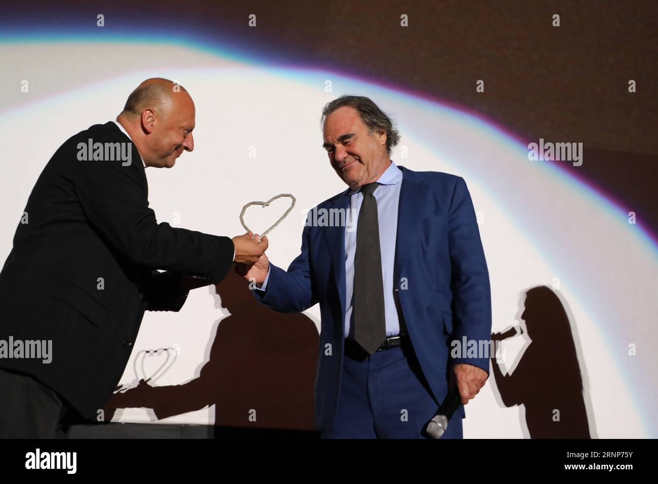 (170814) -- SARAJEVO, Aug. 14, 2017 -- Famous U.S. film director Oliver Stone (R) receives the Honorary Heart of Sarajevo Award from the festival director Mirsad Purivatra (L) during the 23rd Sarajevo Film Festival(SFF) in Sarajevo, Bosnia and Herzegovina, on Aug. 13, 2017. )(yk) BOSNIA AND HERZEGOVINA-SARAJEVO-SARAJEVO FILM FESTIVAL HarisxMemija PUBLICATIONxNOTxINxCHN   170814 Sarajevo Aug 14 2017 Famous U S Film Director Oliver Stone r receives The Honorary Heart of Sarajevo Award from The Festival Director Mirsad Purivatra l during The 23rd Sarajevo Film Festival SFF in Sarajevo Bosnia and Stock Photo