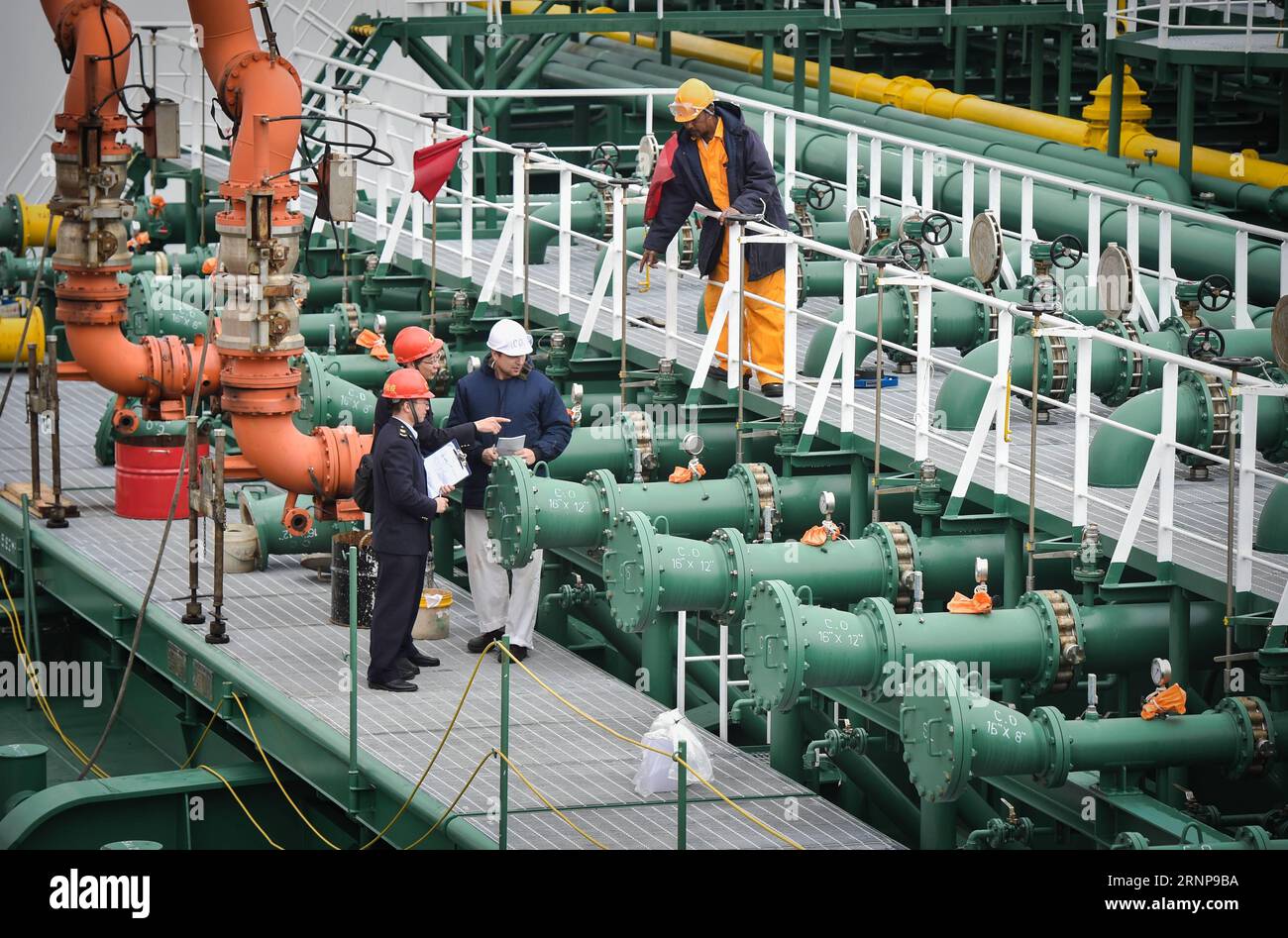 (170817) -- QUANZHOU, Aug. 17, 2017 -- Immigration and Quarantine personnels check a foreign oil tanker at a port in Quanzhou City, southeast China s Fujian Province, Jan. 21, 2016. Quanzhou, a port city known as the starting point of the ancient maritime silk road, has one of the richest religious and ethnic blends in the country. It is dubbed the religious museum. Cultural heritage from ancient churches, mosques and temples testify to the different cultural exchanges that were brought in alongside trade. Quanzhou received a recommendation from the UNESCO China office in January to apply for Stock Photo