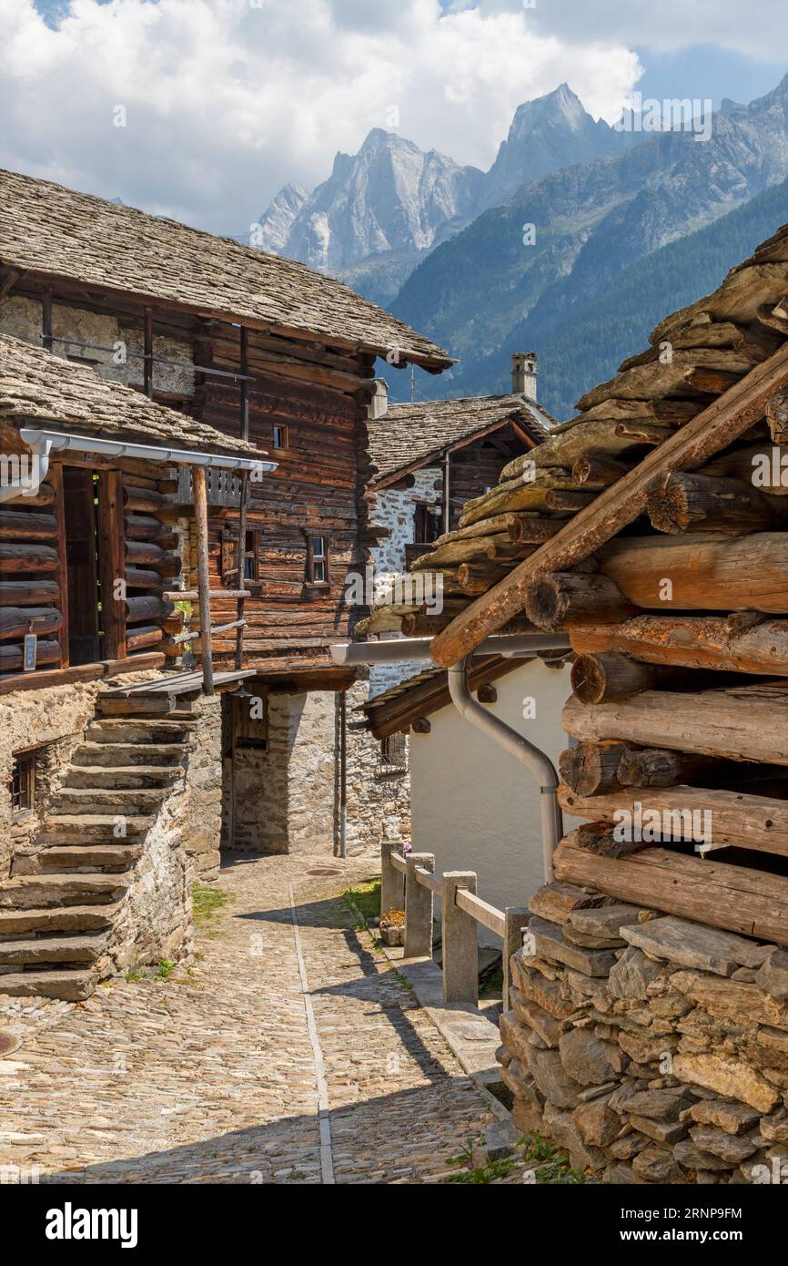 The Soglio village and Piz Badile, Pizzo Cengalo, and Sciora peaks in the Bregaglia range - Switzerland. Stock Photo