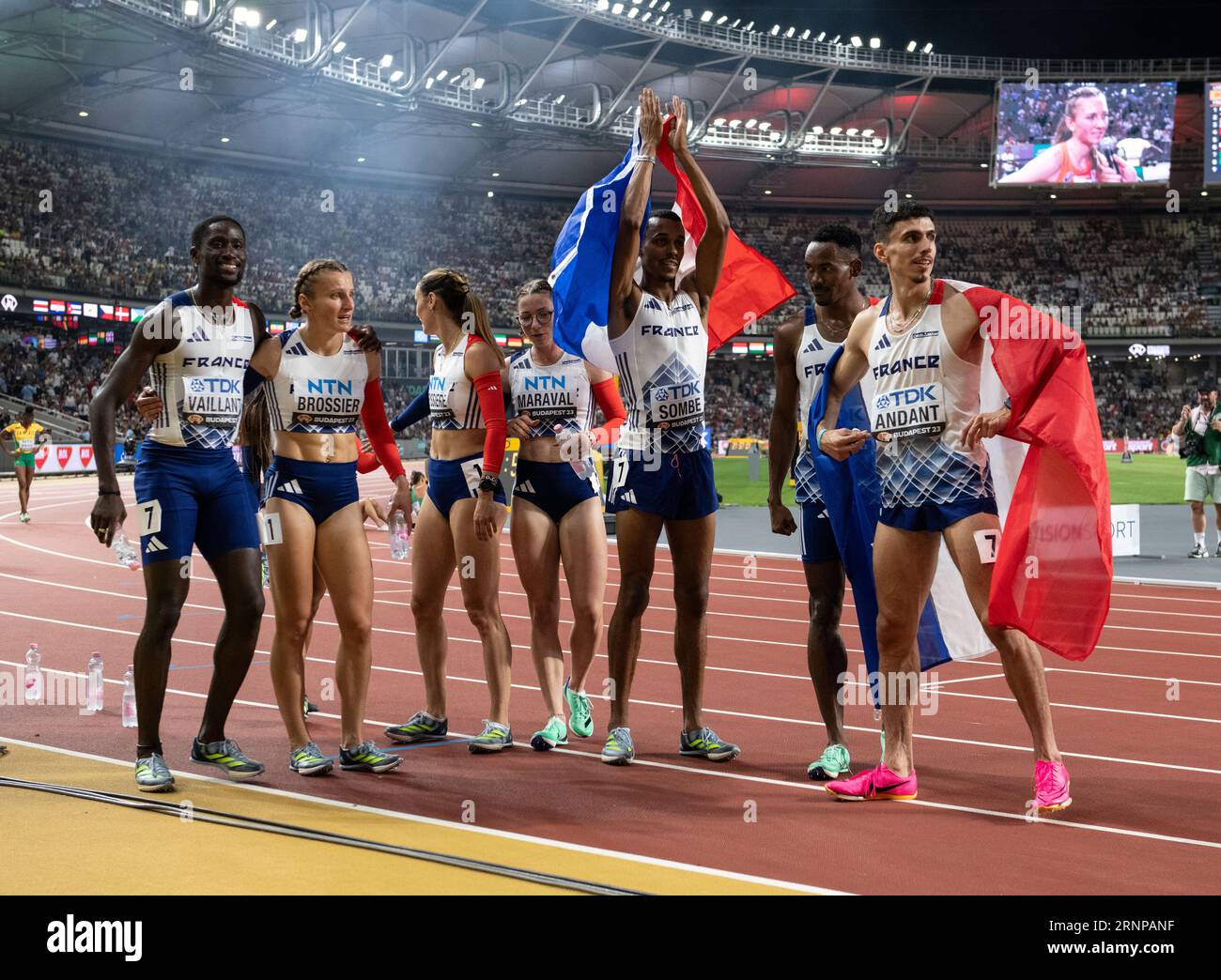 Team france men's and women celebrate after competing in the 4x400m