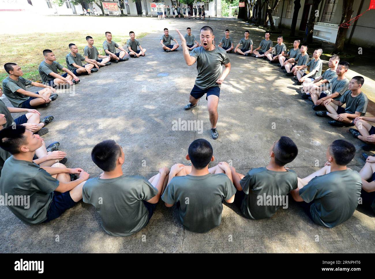 (170830) -- LIUZHOU, Aug. 30, 2017 -- Deng Feng (C) performs military fist as he takes part in a training for joining the army in Liuzhou, south China s Guangxi Zhuang Autonomous Region, Aug. 30, 2017. Deng, 24, who just graduated from Xingjian College of Science and Liberal Arts of Guangxi University, has signed for the army twice. When he was a freshman, Deng Feng was for the first time recruited as a soldier of Guangxi Frontier Corps of Chinese Armed Police and was on service for two years. Deng Feng then left army and went back to Guangxi University until he finished his study. Upon gradua Stock Photo