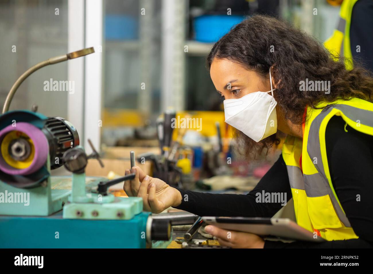 woman worker working in heavy metal industry workshop wearing facemask for hygiene healthy safety Stock Photo