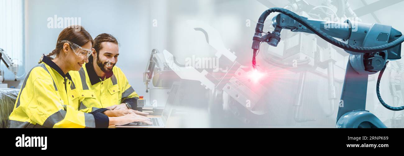 engineer team working with welding robot arm for industry technology advertising wide banner Stock Photo