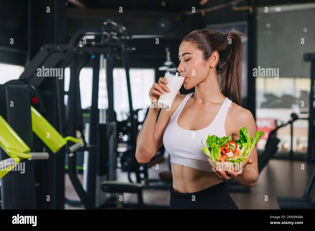 sport healthy woman drinking milk and vegetable good source of whey protein and vitamin for muscle healthcare Stock Photo