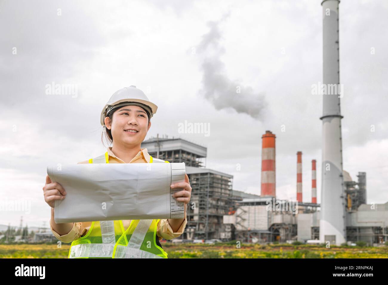 Engineer woman worker with floor plan industry construction designer project manager looking site field working Stock Photo