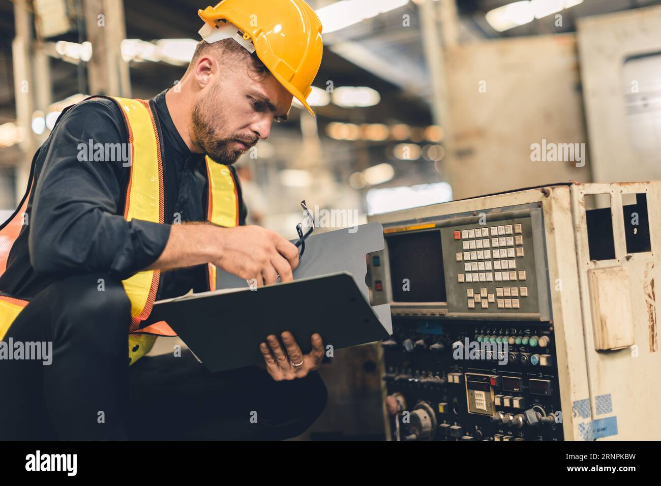 portrait engineer male worker schedule machine service check. inspector staff work in heavy industry for safety Stock Photo