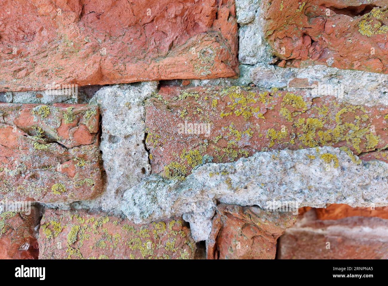 Ancient medieval red brick wall. wall texture background. The wall is partially collapsed. Stock Photo