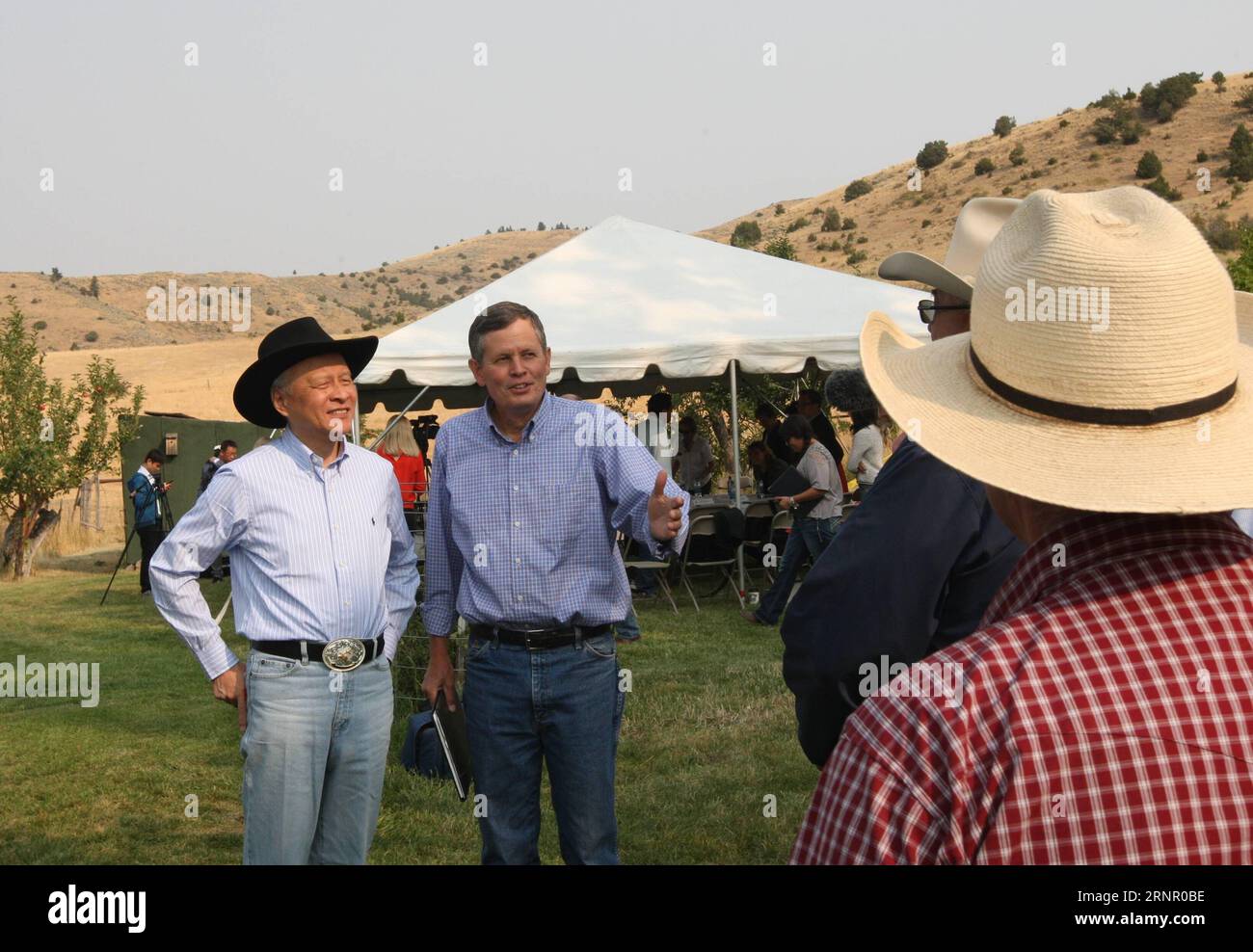 (170912) -- BOZEMAN (U.S.), Sept. 12 -- Steve Daines (2nd L), a senator from U.S. state of Montana, and Cui Tiankai (1st L), Chinese Ambassador to the United State, speaks with Fred Wacker and other cattle ranchers at the Morgan Ranch House, near downtown Bozeman, Montana, the United States, on Sept. 8, 2017. We re very excited that China removed a ban on U.S. beef imports, said Fred Wacker, a third-generation rancher of Miles City in the northwestern U.S. state of Montana, where there re about three heads of cattle for every person. Two months ago, as part of the 100-day action plan to boost Stock Photo