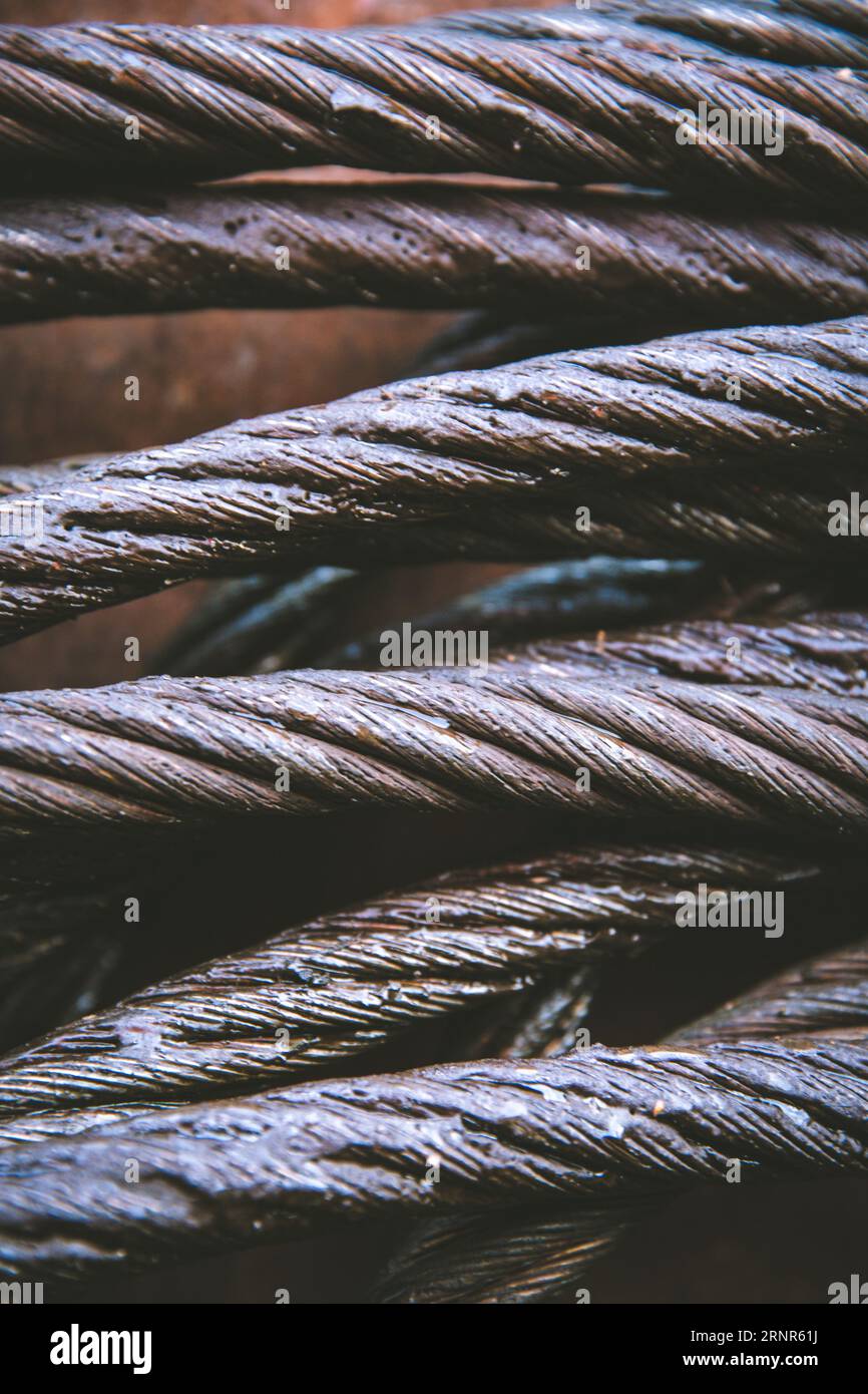 A full frame close up of strong metal cable used in shipping or construction that has been greased to protect from rust with copy space Stock Photo