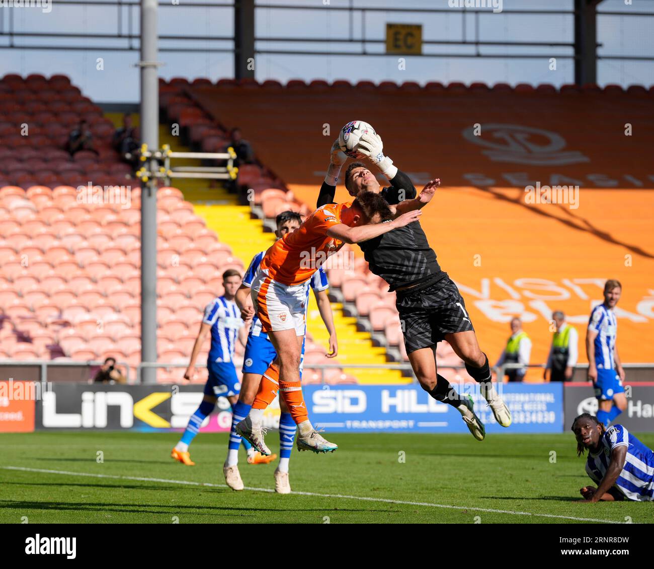 Sam Tickle 1 of Wigan Athletic competes for a cross with Callum