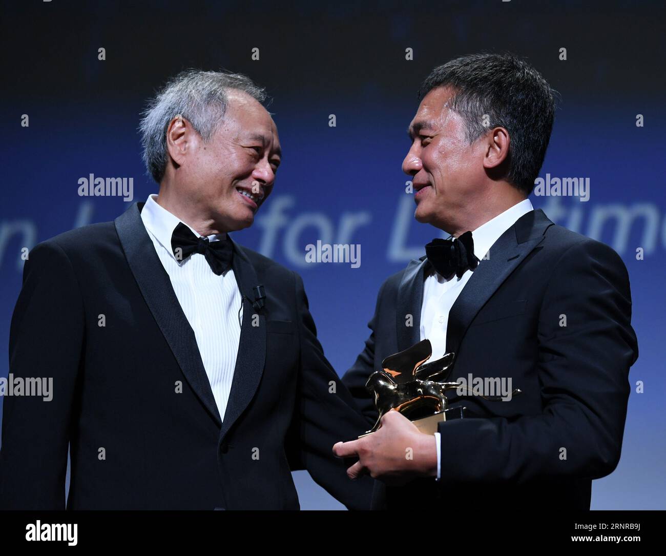 Venice, Italy. 2nd Sep, 2023. Director Ang Lee (L) and Actor Tony Leung Chiu-Wai attend an award ceremony during the 80th Venice International Film Festival in Venice, Italy, on Sept. 2, 2023. Tony Leung Chiu-Wai of Hong Kong, China was presented with the Golden Lion for Lifetime Achievement during the event on Saturday. Credit: Jin Mamengni/Xinhua/Alamy Live News Stock Photo