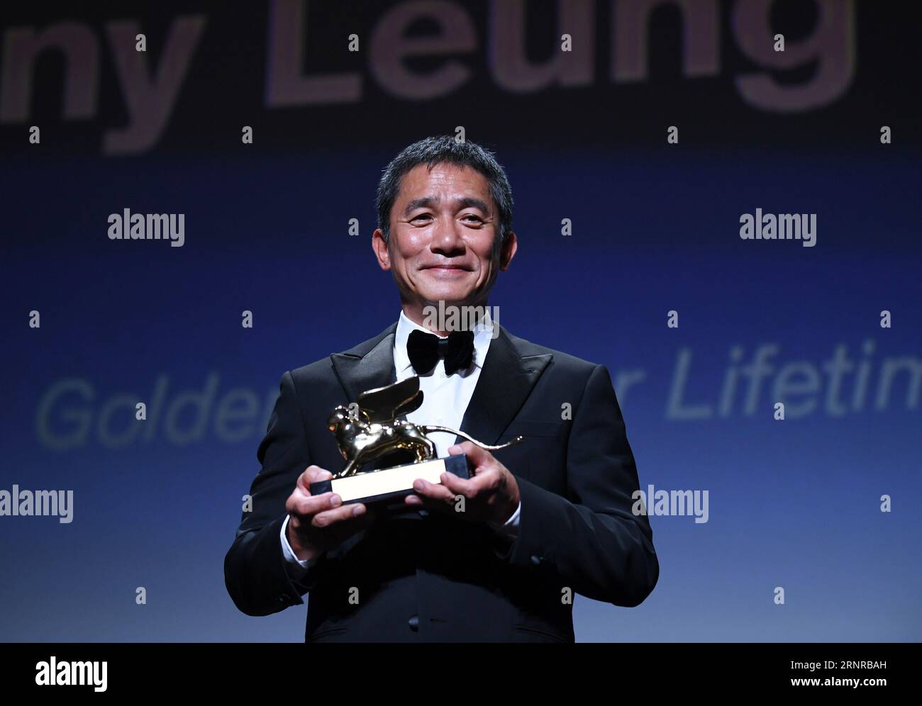 Venice, Italy. 2nd Sep, 2023. Actor Tony Leung Chiu-Wai poses with his trophy at an award ceremony during the 80th Venice International Film Festival in Venice, Italy, on Sept. 2, 2023. Tony Leung Chiu-Wai of Hong Kong, China was presented with the Golden Lion for Lifetime Achievement during the event on Saturday. Credit: Jin Mamengni/Xinhua/Alamy Live News Stock Photo