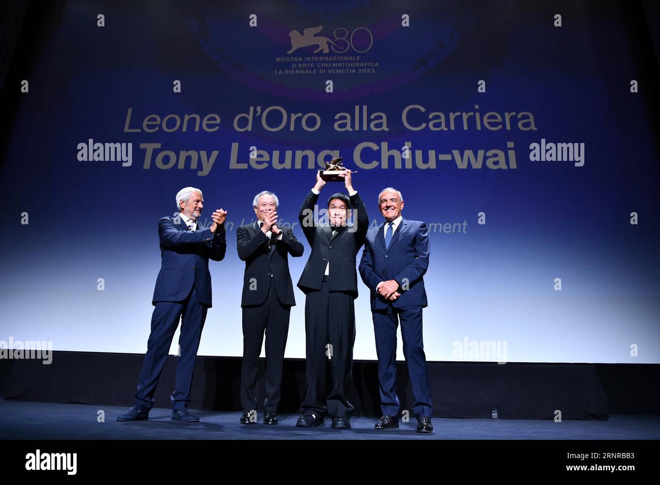 Venice, Italy. 2nd Sep, 2023. Actor Tony Leung Chiu-Wai (2nd, R) poses with his trophy at an award ceremony during the 80th Venice International Film Festival in Venice, Italy, on Sept. 2, 2023. Tony Leung Chiu-Wai of Hong Kong, China was presented with the Golden Lion for Lifetime Achievement during the event on Saturday. Credit: Jin Mamengni/Xinhua/Alamy Live News Stock Photo