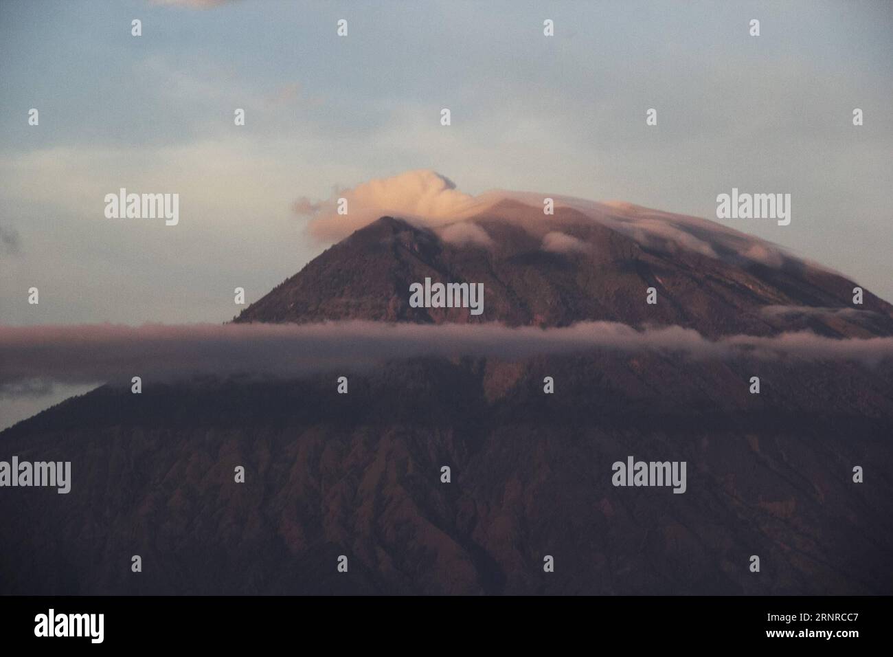 (170926) -- BALI, Sept. 26, 2017 -- Smoke rises from the Gunung Agung, or Mount Agung volcano at Amed beach in Karangasem regency, Bali, Indonesia. Sept. 26, 2017. The number of evacuees has risen to more than 57,000 as Gunung Agung volcano in Bali resort island is potential to erupt, a senior official of disaster agency said on Tuesday. ) (gj) INDONESIA-BALI-MOUNT AGUNG M.xFauzixChaniago PUBLICATIONxNOTxINxCHN Stock Photo