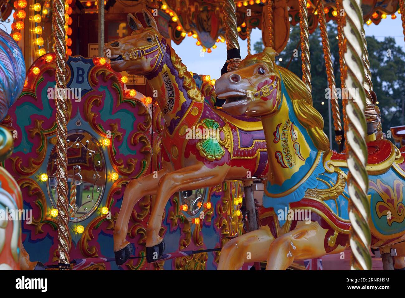 horses on a merry go round, a British fairground ride Stock Photo