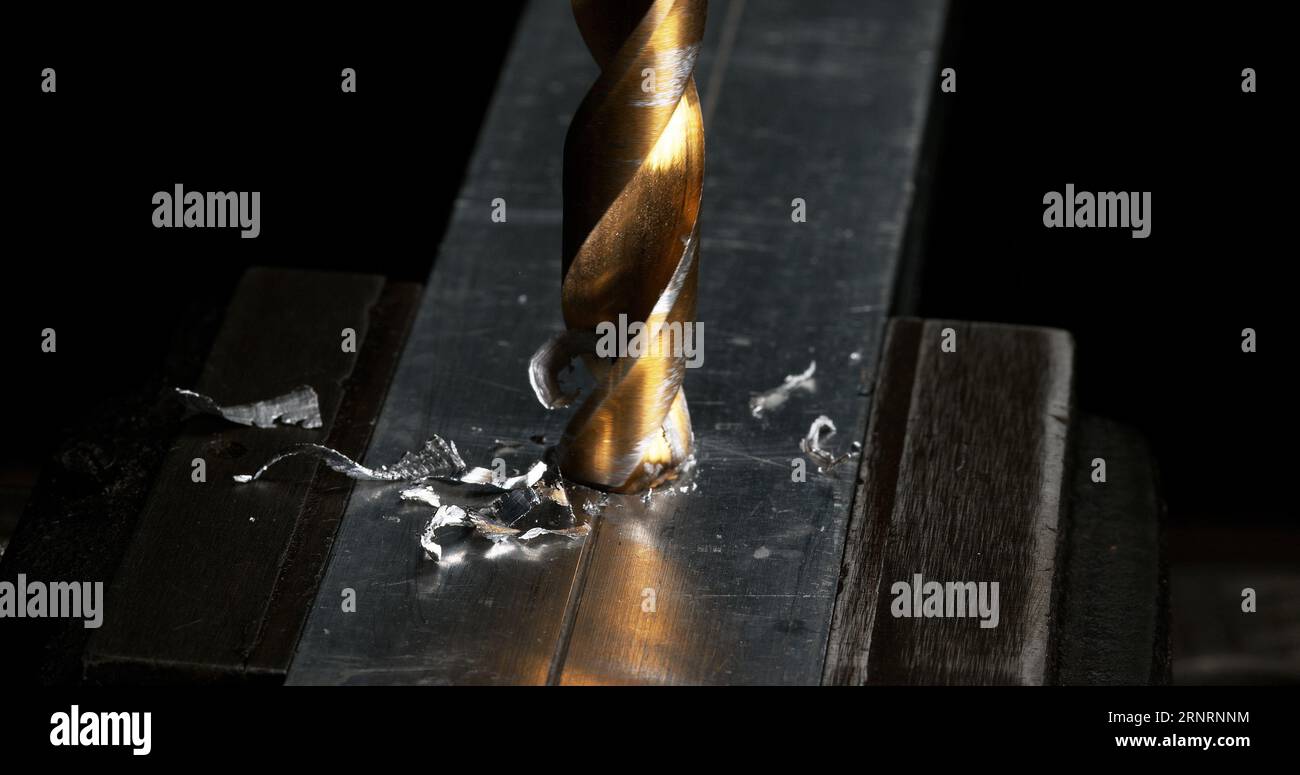 Metal Drill Turning on a Steel Plate Making Chips Stock Photo Alamy