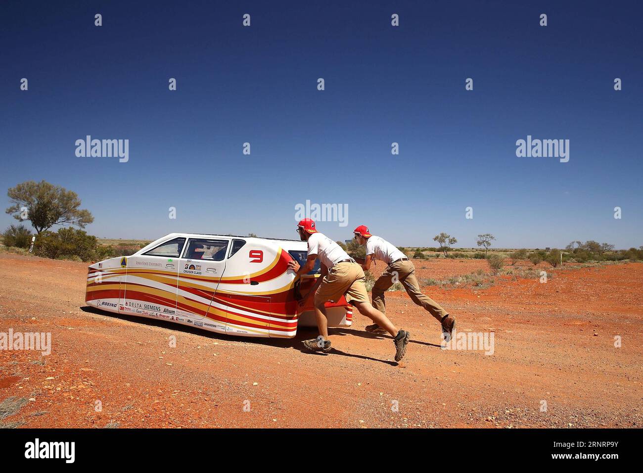 (171012) -- CANBERRA, Oct. 12, 2017 -- Team members of PrISUn from the USA push their vehicle Penumbra back to the Stuart Highway after a break from the racing between Marla Bora and Coober Pedy, South Australia, during the hallenge on Oct. 12, 2017. hallenge) (SP)AUSTRALIA-CANBERRA-2017 WORLD SOLAR CHALLENGE 2017xBridgestonexWorldxSolarxC PUBLICATIONxNOTxINxCHN Stock Photo
