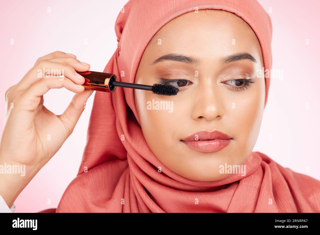 Beauty, makeup and mascara with a muslim woman closeup in studio on a 