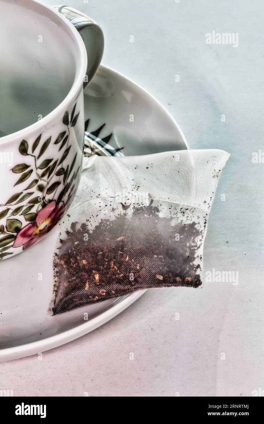 Closeup of a biodegradable teabag on find bone china cup and saucer