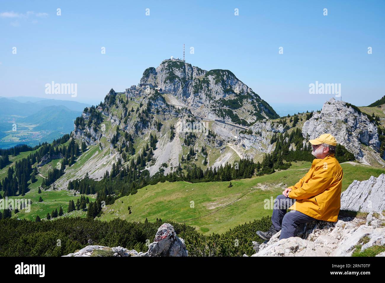 Hiker, senior, 65, enjoying the view from the Lacherspitz to the Wendelstein, Bayrischzell, Mangfall Mountains, Upper Bavaria, Germany Stock Photo