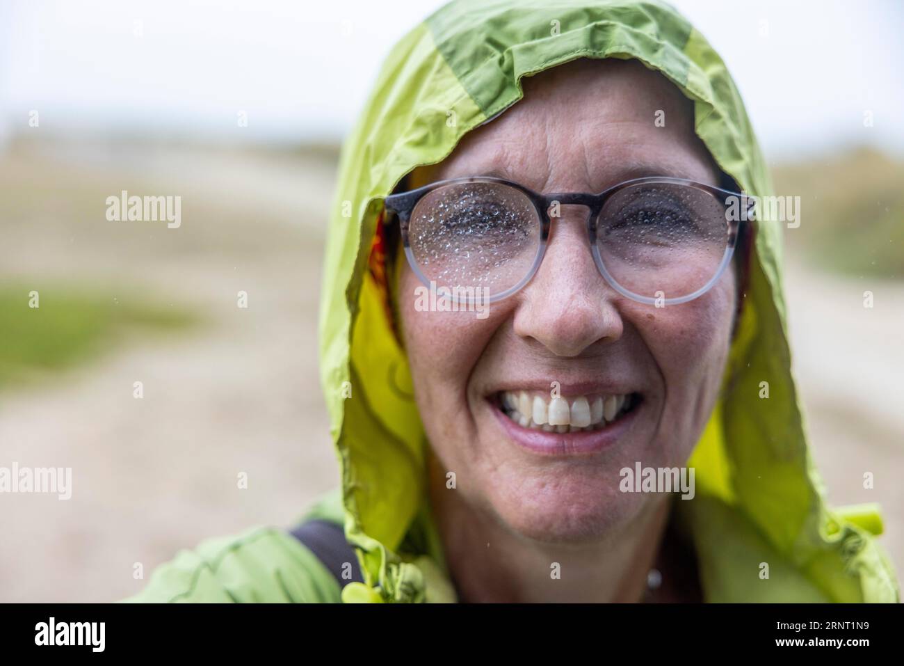 Woman with rain jacket and raindrops on her glasses comes back soaked ...