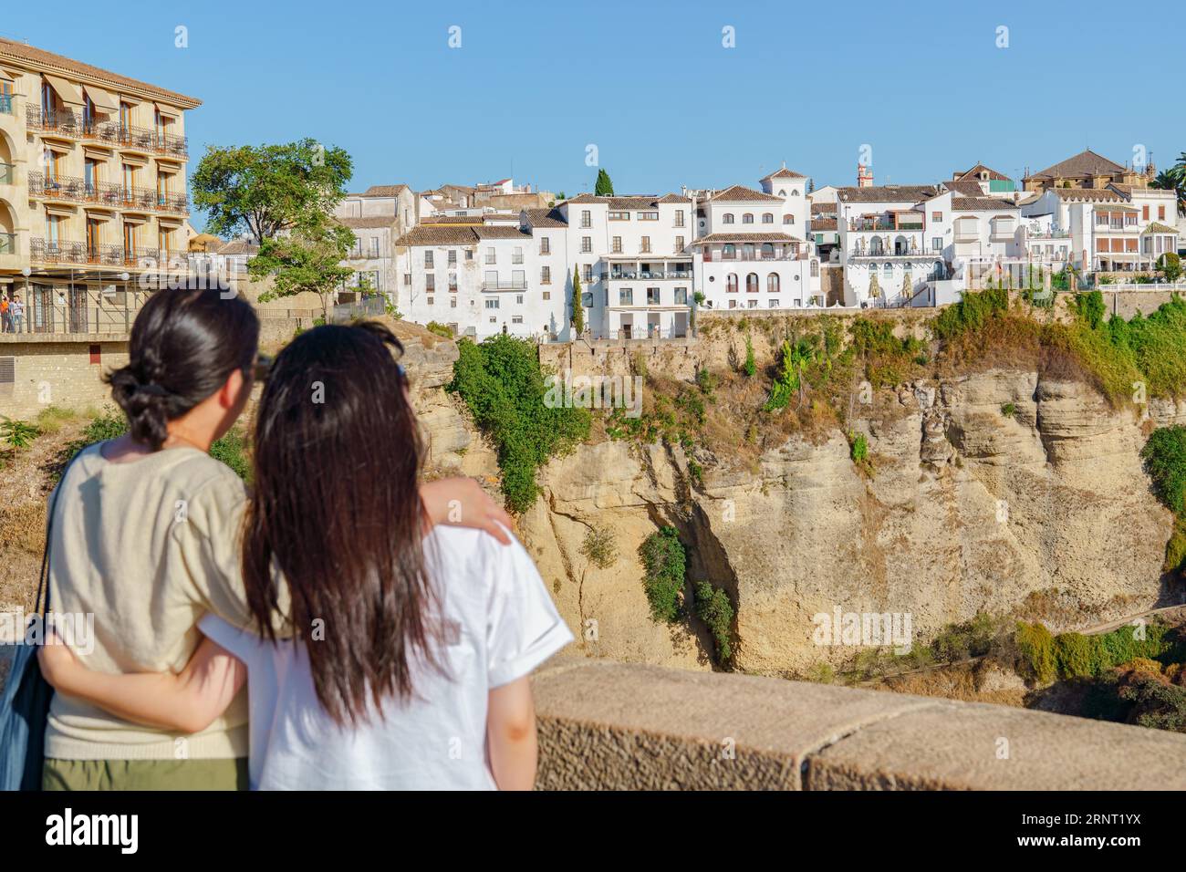 Tourist couple hugging admiring the city of ronda, malaga, spain Stock Photo