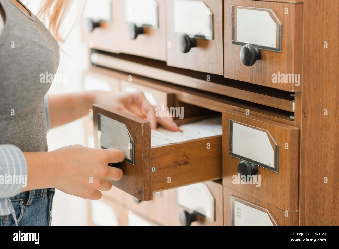 Crop librarian searching bibliographic item Stock Photo