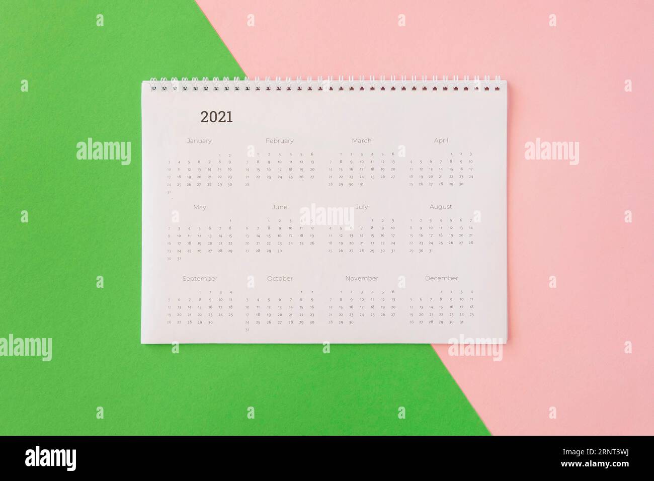 Flat lay desk calendar coloured background Stock Photo - Alamy