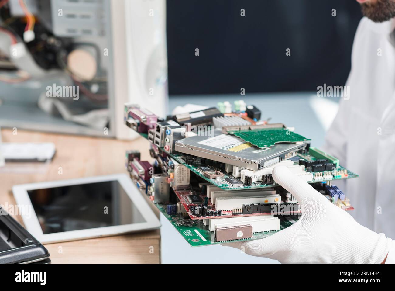 Male technician hand wearing gloves holding computer parts Stock Photo