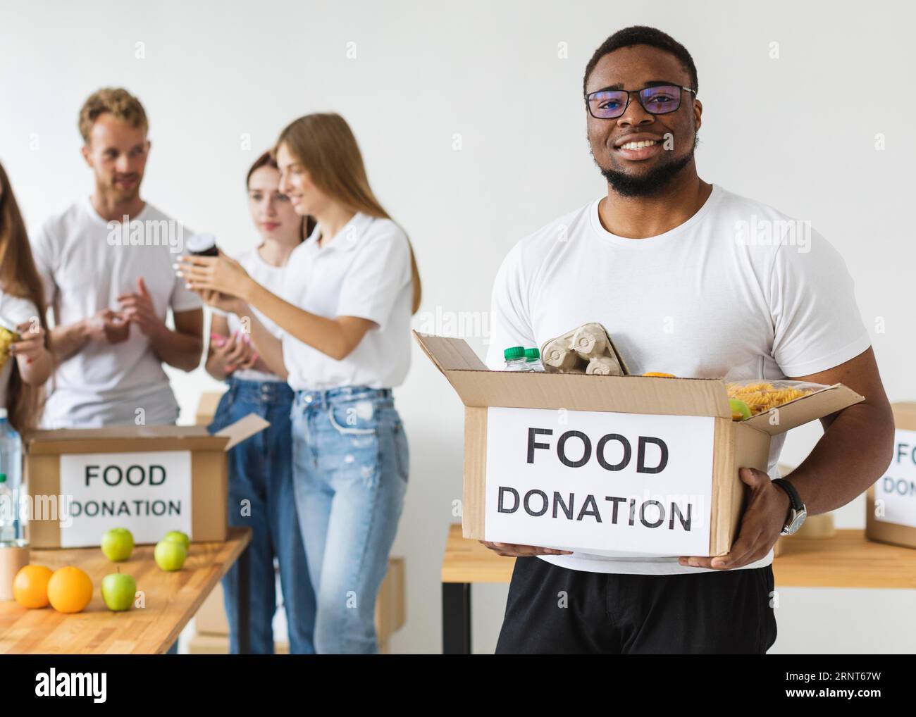 Male volunteer holding donations hi-res stock photography and images ...