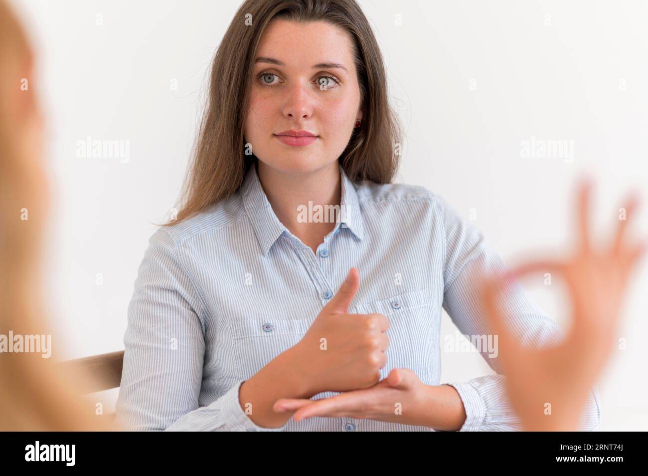 Woman having conversation with someone using sign language Stock Photo
