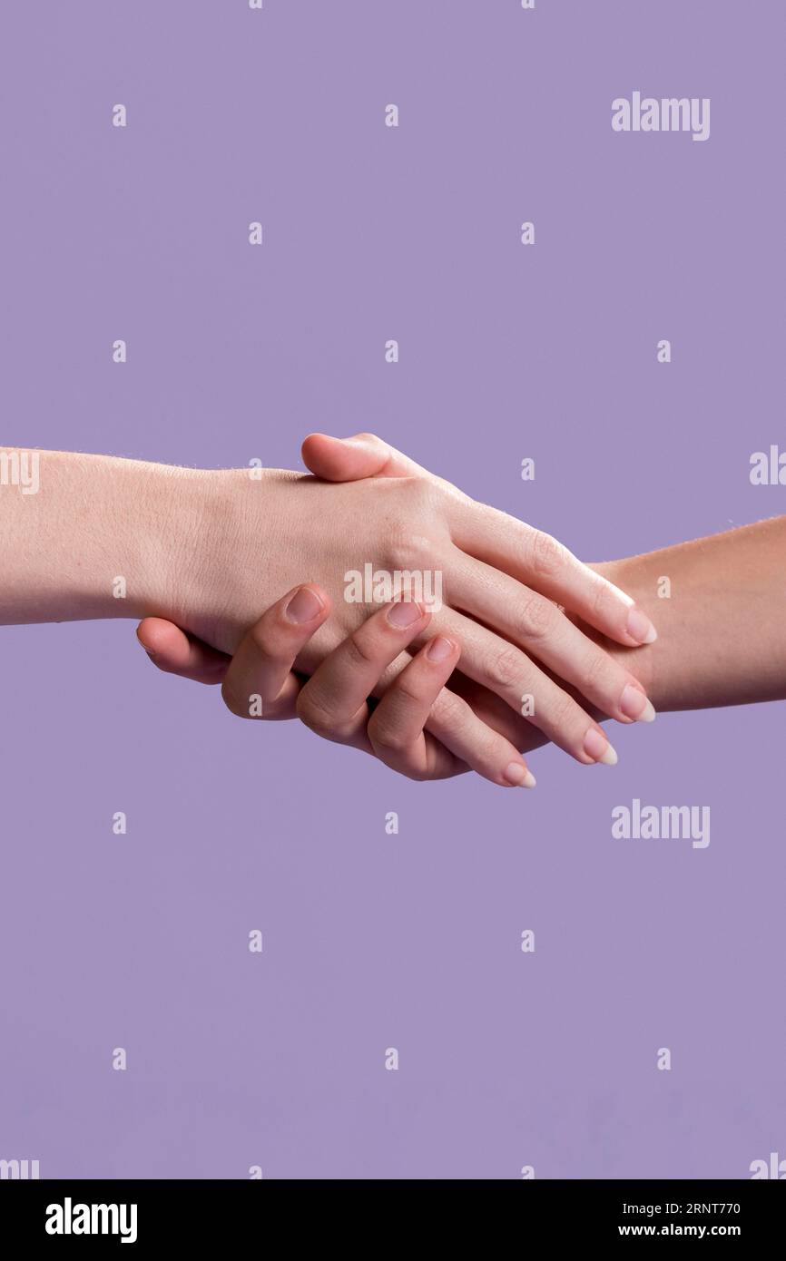 Women handshake as sign unity Stock Photo