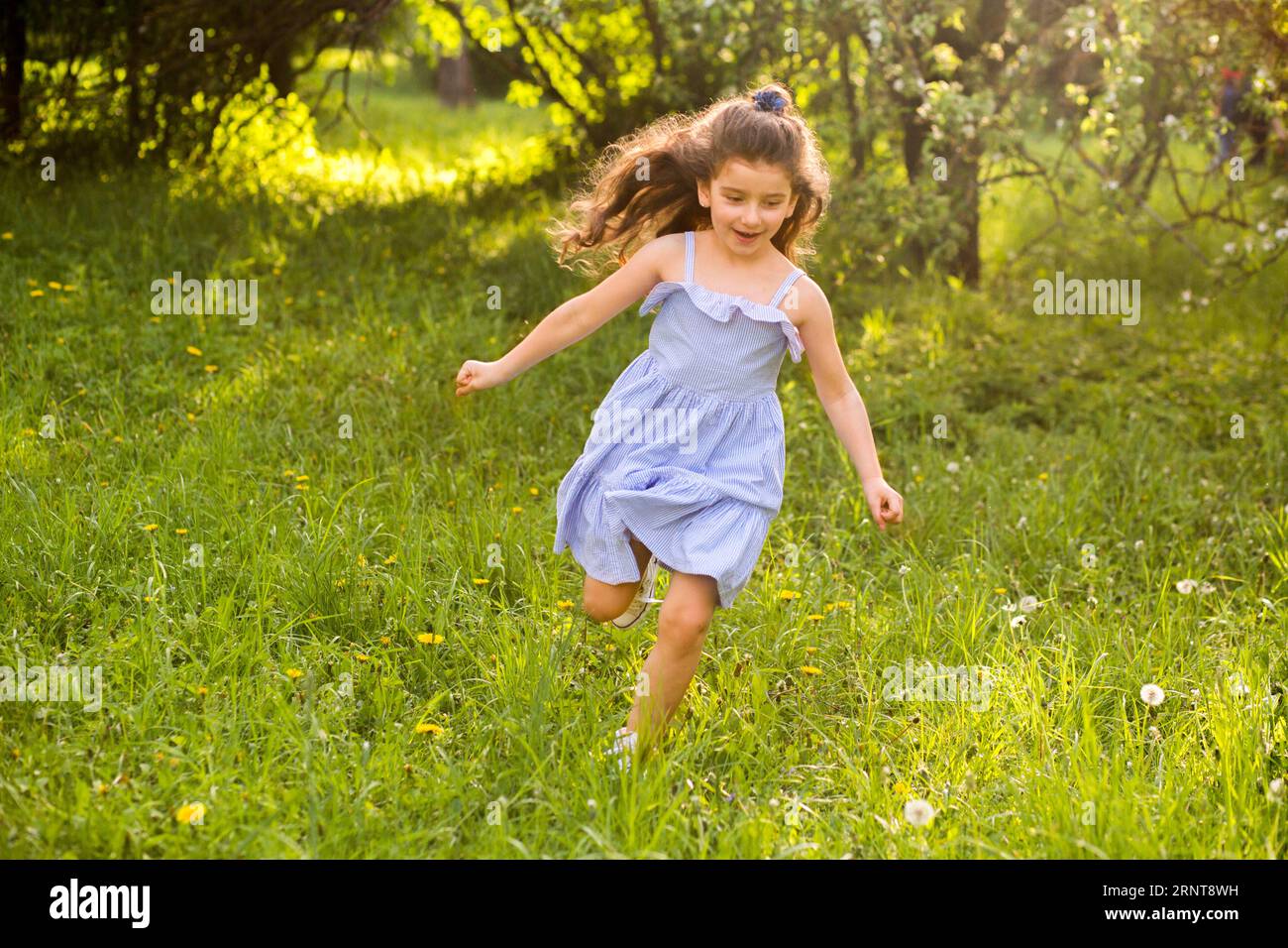 Cute little girl running garden Stock Photo