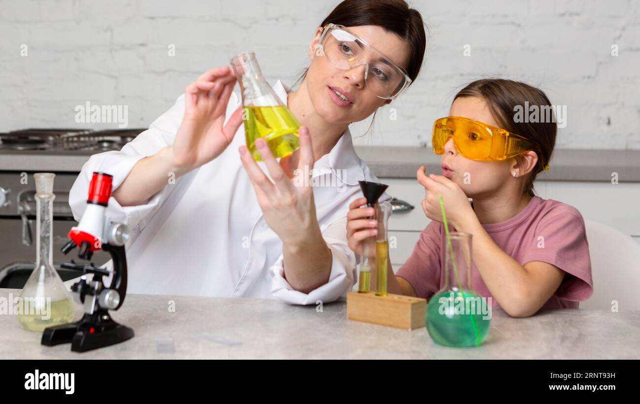 Female teacher girl doing science experiments Stock Photo