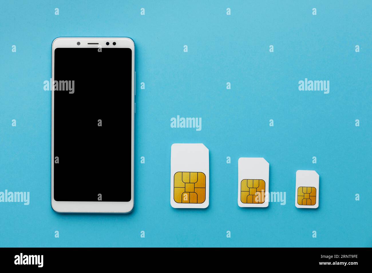 Top view three sim cards with smartphone copy space Stock Photo
