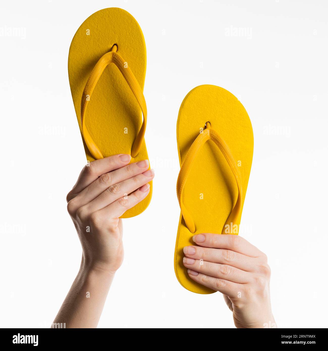 Hands holding flip flops Stock Photo - Alamy